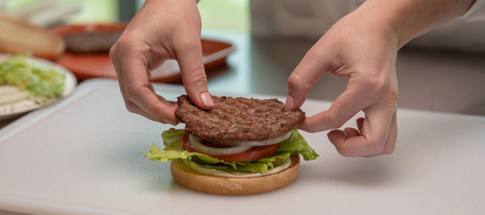 Hardee's worker assembling burger